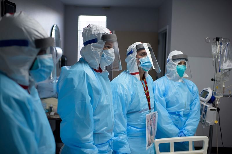 Healthcare workers listen as Chief of Staff Doctor Joseph Varon talks to them in the Covid-19 ward at United Memorial Medical Center in Houston, Texas on 4 December 2020. Joseph Varon, a physician treating coronavirus patients at a Texas hospital, was working his 252nd day in a row when he spotted a distraught elderly man in the COVID-19 intensive care unit (ICU).