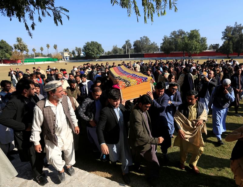 Afghan men carry the coffin of journalist Malalai Maiwand, who was shot and killed by unknown gunmen in Jalalabad, Afghanistan 10 December, 2020