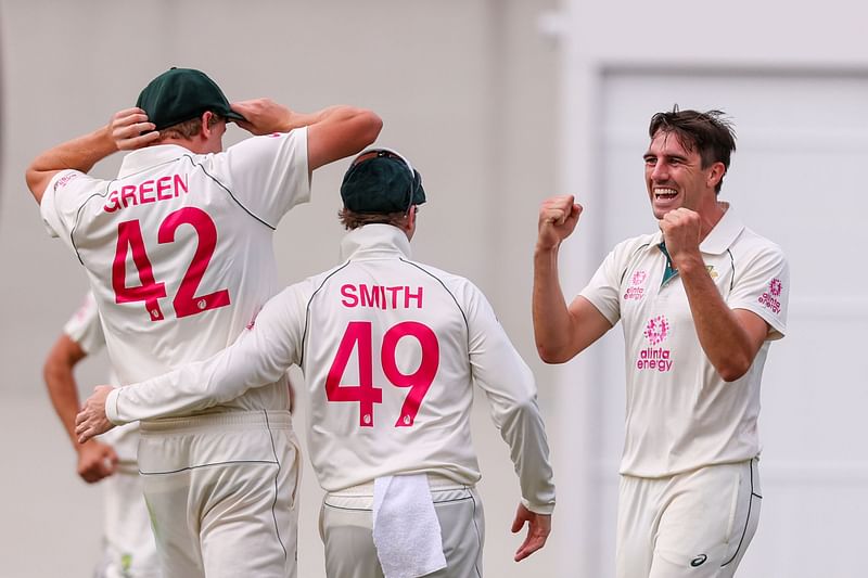 Australia's Pat Cummins (R) celebrates with teammates after dismissing India's Shubman Gill (not pictured) during the second day of the third cricket Test match between Australia and India at the Sydney Cricket Ground (SCG) in Sydney on 8 January 2021