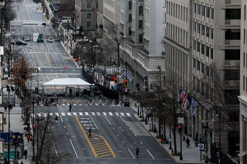 People make their way through barricades installed ahead of US president-elect Joe Biden's inauguration, in Washington, US, on 16 January 2021