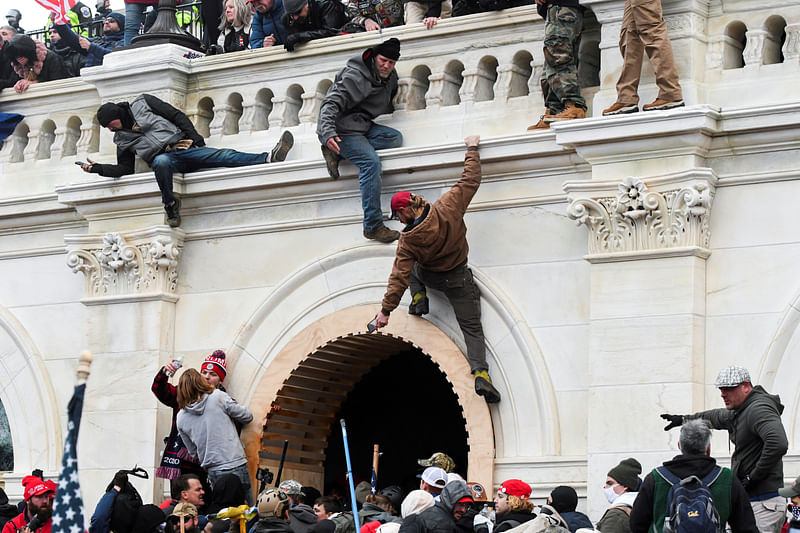 Supporters of US president Donald Trump climb on walls at the US Capitol during a protest against the certification of the 2020 US presidential election results by the US Congress, in Washington, US, on 6 January 2021