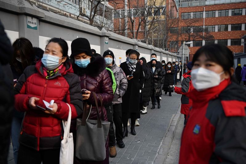 People line up to be tested for the COVID-19 coronavirus in Beijing on 22 January, 2021, part of a drive to test two million people in 48 hours as the city rushes to snuff out a new local cluster of cases believed to be linked to a more contagious virus variant