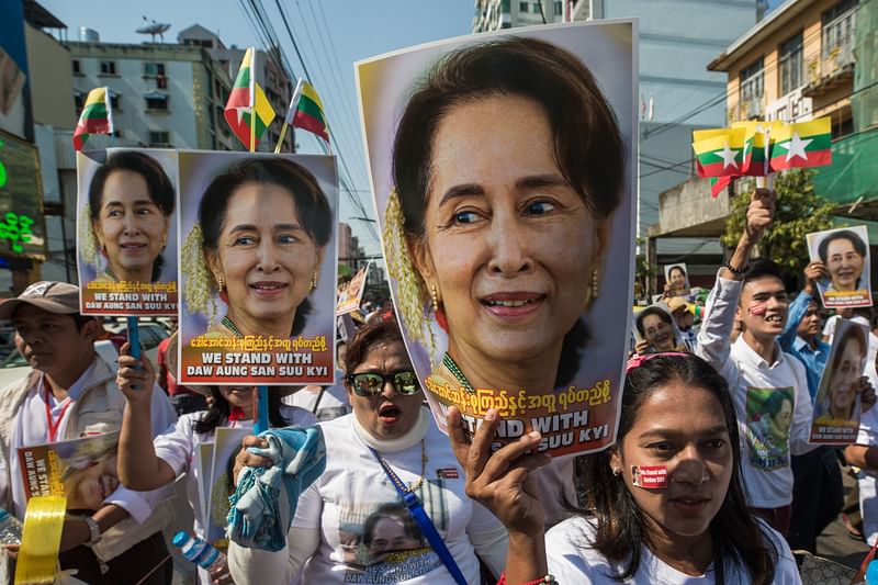 In this file photo taken on 10 December 2019 people participate in a rally in support of Myanmar's State Counsellor Aung San Suu Kyi, as she prepares to defend Myanmar at the International Court of Justice in The Hague against accusations of genocide against Rohingya Muslims