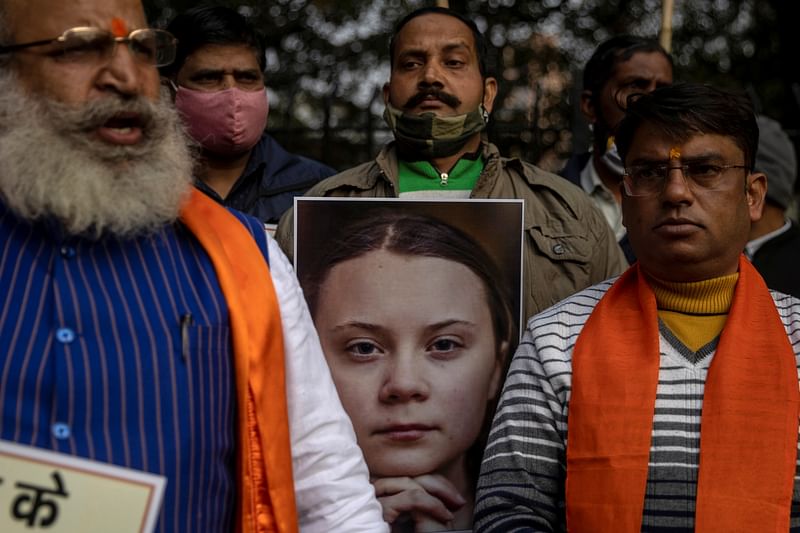 Activists from United Hindu Front hold a portrait of climate change activist Greta Thunberg before burning it, to protest against the celebrities for commenting in support of protesting farmers, in New Delhi, India, 4 February 2021.