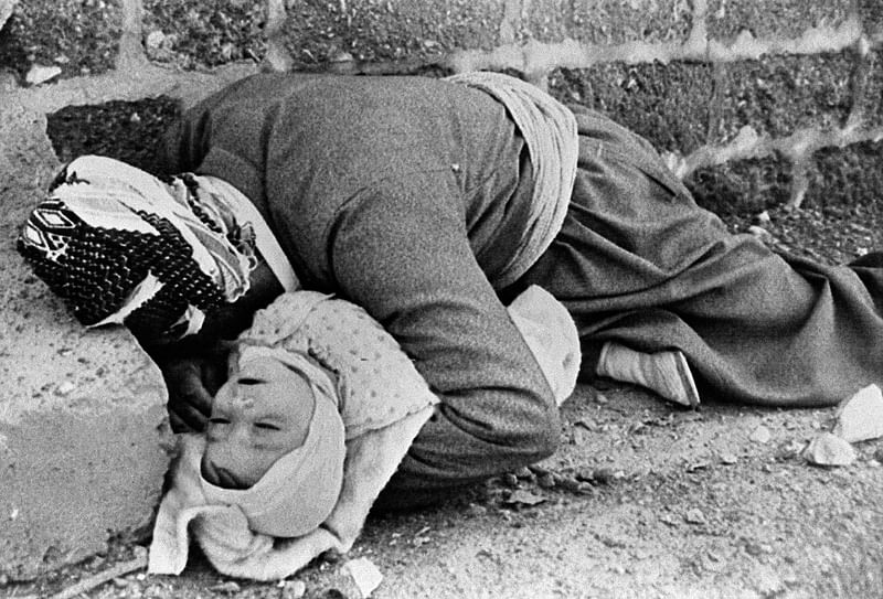 A file handout black and white picture released by the Iranian official news agency IRNA on  20 March 1988, shows a Kurdish father holding his baby in his arms, both killed by an Iraqi chemical attack on the Kurdish city of Halabja in northeastern Iraq in March 1988