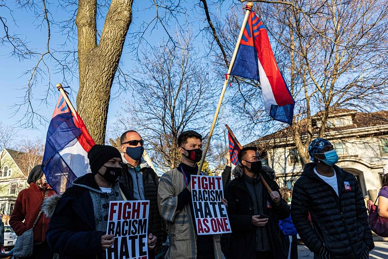 People hold flags of the Karen National Union during the "Asian Solidarity March" rally against anti-Asian hate in response to recent anti-Asian crime on 18 March 2021 in Minneapolis, Minnesota