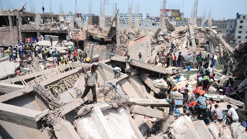 In this photograph taken on 24 April 2013, Bangladeshi civilian volunteers assist in rescue operations after an eight-storey Rana Plaza collapsed in Savar, on the outskirts of Dhaka