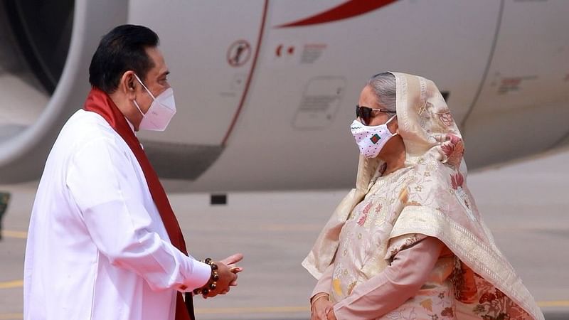 Bangladesh prime minister Sheikh Hasina welcomes Sri Lanka prime minister Mahinda Rajapaksa at Dhaka airport on 19 March 2021