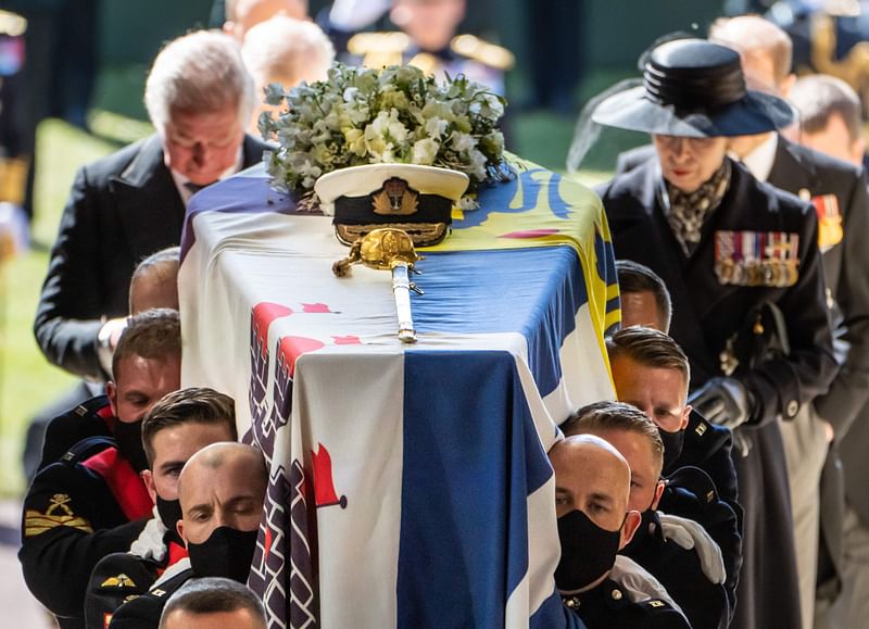 Pall Bearers carry the coffin of Britain's Prince Philip, Duke of Edinburgh, followed by members of the Royal family inside St George's Chapel in Windsor Castle in Windsor, west of London, on 17 April