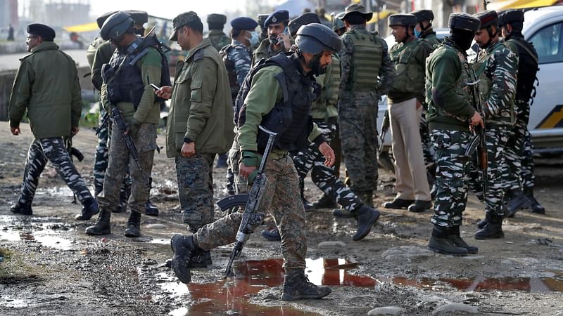 India's security force personnel stand guard at the site of an attack on Central Reserve Police Force (CRPF) troopers by suspected militants on the outskirts of Srinagar on 25 March 2021