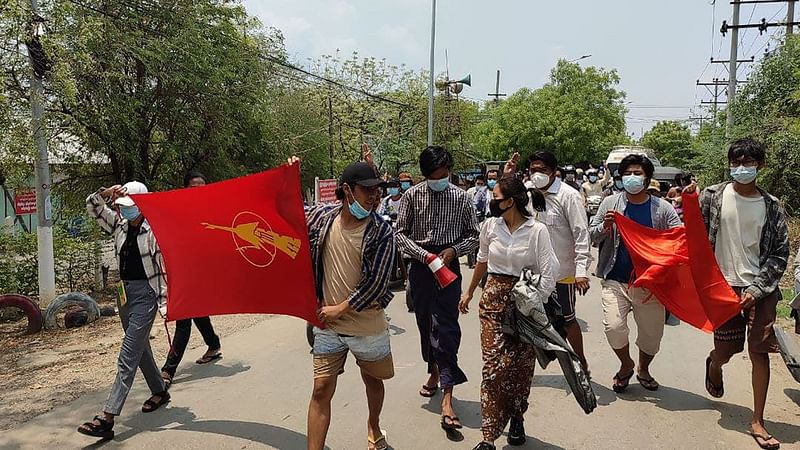 This photo taken and received on 19 April 2021 courtesy of an anonymous source via Facebook shows student protesters marching during a demonstration against the military coup in Mandalay