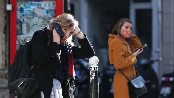 A woman talks on the phone in Paris, France, on 9 November 2020