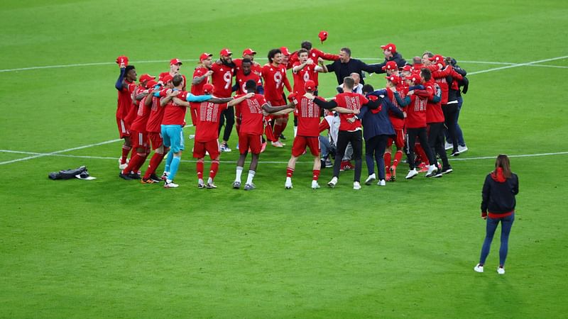 Bayern Munich's players and team members celebrate after they won the German first division Bundesliga football match FC Bayern Munich v Borussia Moenchengladbach in Munich, southern Germany on 8 May 2021