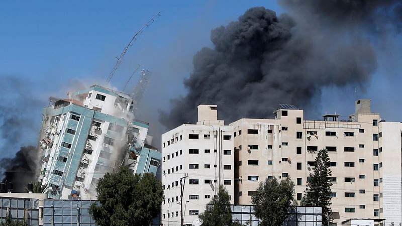 A tower housing AP, Al Jazeera offices collapses after Israeli missile strikes in Gaza city, 15 May