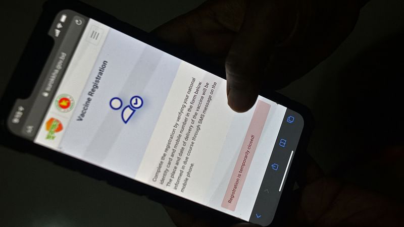 In this photo illustration taken on 21 May 2021, a user checks a government website on a mobile phone that is temporarily been closed for the Covid-19 coronavirus vaccine registration, in Dhaka.