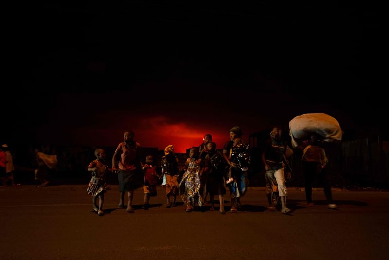 Goma residents are seen leaving the city following a sudden activity of the Nyiragongo volcano on 22 May 2021