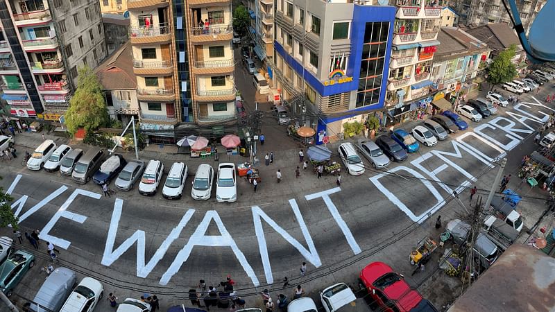 A slogan is written on a street as a protest after the coup in Yangon, Myanmar on 21 February 2021. Picture taken with iPhone panoramic mode