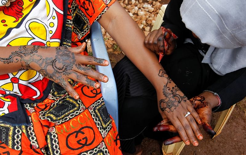 Muslim women apply henna paste after performing Eid prayers, amid the coronavirus disease (COVID-19) pandemic, on the first day of Eid al-Fitr, in Nairobi, Kenya 13 May