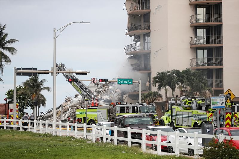 Emergency crews respond to a partially collapsed residential building in the rain in Surfside, near Miami Beach Florida, US on 24 June 2021.