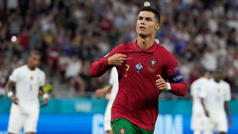 Portugal's forward Cristiano Ronaldo celebrates after scoring a penalty kick during the UEFA EURO 2020 Group F football match between Portugal and France at Puskas Arena in Budapest on 23 June 2021