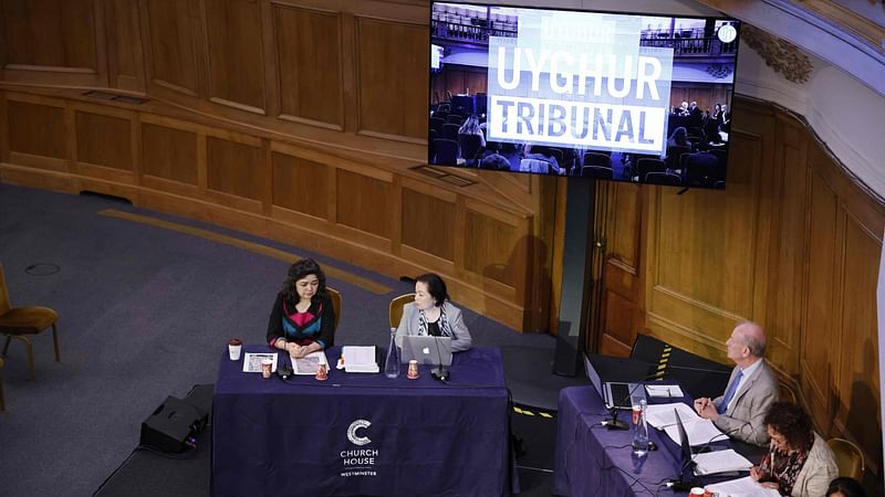 Witness Uyghur teacher Qelbinur Sidik (L) speaks on the first day of hearings at the "Uyghur Tribunal", a panel of UK-based lawyers and rights experts investigating alleged abuses against Uyghurs in China, in London on 4 June 2021