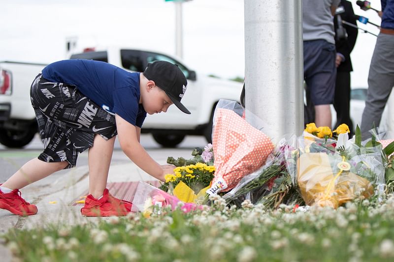 A young Londoner leaves a Hulk Action Figure for the nine year old boy who remains in hospital with serious injuries, at the scene where a man driving a pickup truck struck and killed four members of a Muslim family in London, Ontario, Canada on 7 June 2021