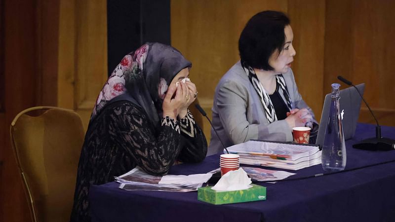 Witness Patigul Talip (L) reacts as she speaks on the first day of hearings at the "Uyghur Tribunal", a panel of UK-based lawyers and rights experts investigating alleged abuses against Uyghurs in China, in London on 4 June, 2021