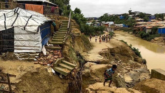 Rohingya children walk around a landslide area at Balukhali refugee camp in Ukhia on 7 July 2019