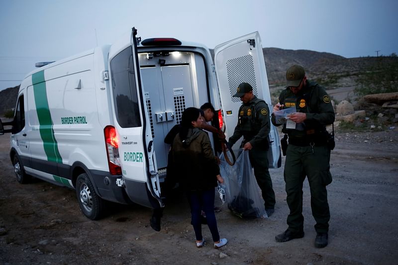 Migrants from Central America crossing into the United States from Mexico, in New Mexico