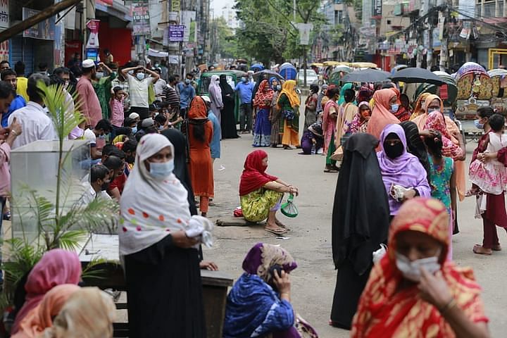 People wait for TCB truck to buy essential goods at a subsidised rate at Farmgate area.