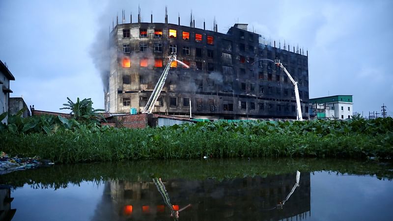 Flames rise the morning after a fire broke out at a factory named Hashem Foods Ltd. in Rupganj of Narayanganj district, on the outskirts of Dhaka, Bangladesh, on 9 July 2021