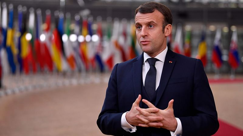 France's president Emmanuel Macron speaks to the press as he arrives at the EU headquarters' Europa building in Brussels on 10 December 2020, prior to a European Union summit