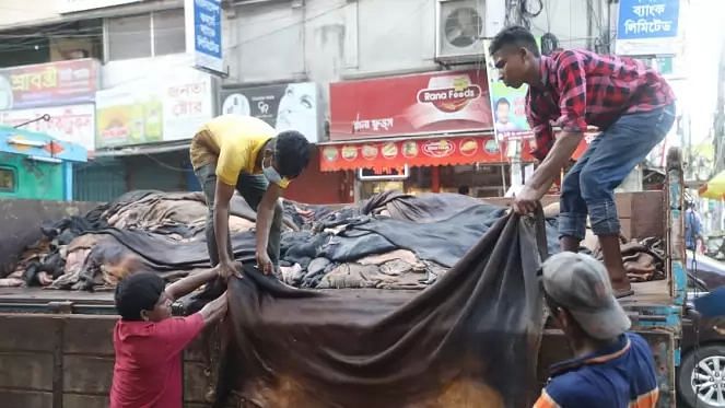 People load rawhide on a truck during Eid-ul-Azha