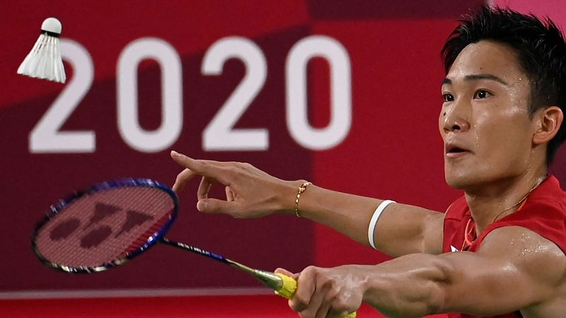 Japan's Kento Momota hits a shot to South Korea's Heo Kwang-hee in their men's singles badminton group stage match during the Tokyo 2020 Olympic Games at the Musashino Forest Sports Plaza in Tokyo on 28 July 2021.