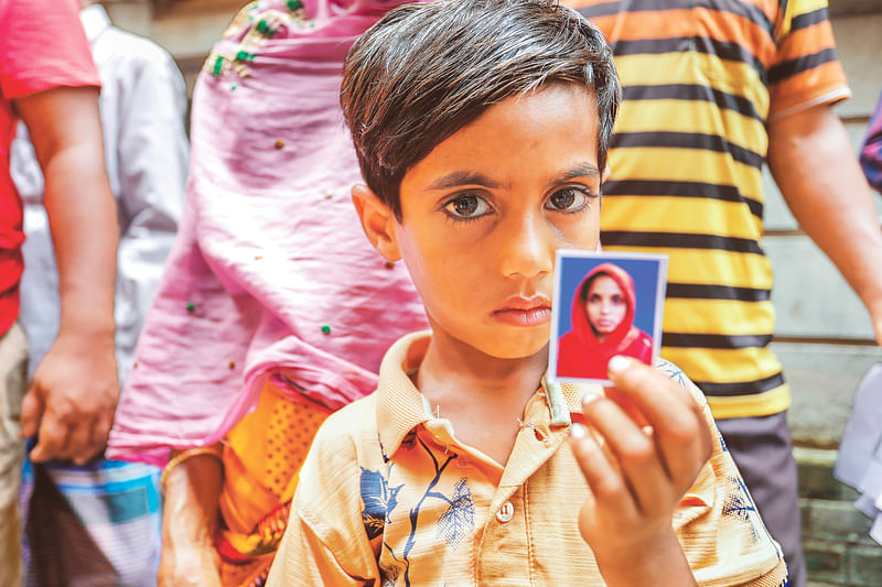 Six-year-old Noyon comes with grandmother in search of his mother at DMCH on Saturday.