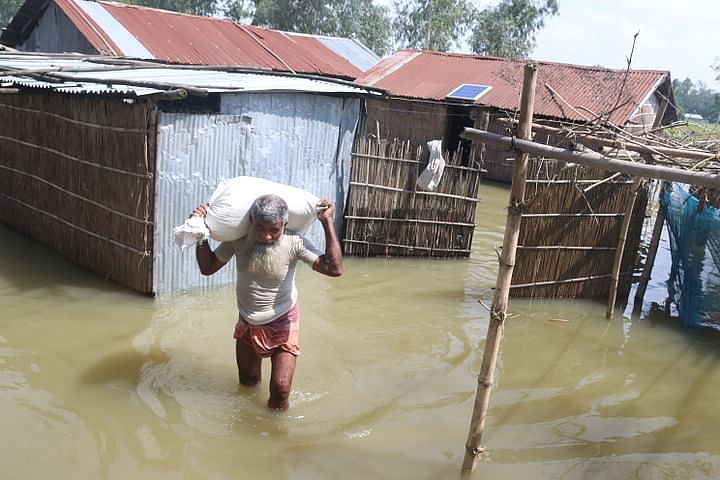 Rangpur is hit by floods as Teesta river water swells. Fazlul Haque heads towards safe place with his belongings as the flood inundates his house at Kolkond area of Gangachara. This picture was taken on 9 July