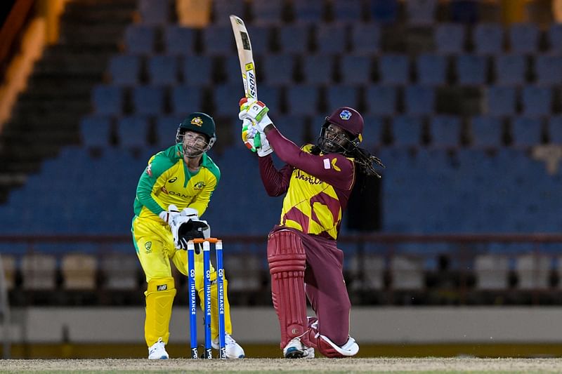 hris Gayle (R) of West Indies hits 6 as Matthew Wade (L) of Australia watches during the 3rd T20I between Australia and West Indies at Darren Sammy Cricket Ground, Gros Islet, Saint Lucia, on 12 July, 2021