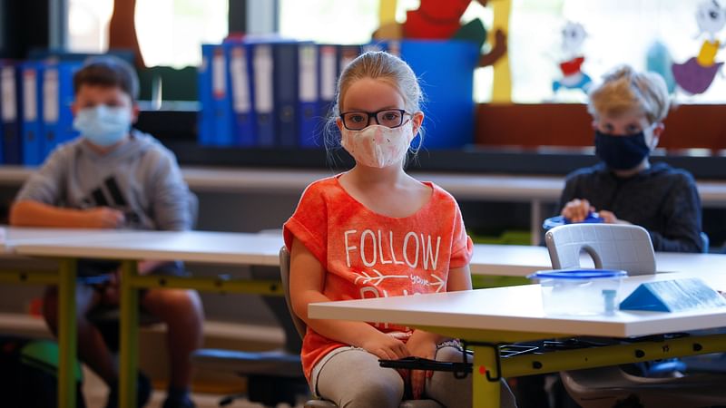 Children wearing protective face masks sit in a classroom at a primary school, as Austrian schools reopen for pupils aged roughly six to 14, during the global coronavirus disease (Covid-19) outbreak, in Brunn am Gebirge, Austria 18 May 2020.