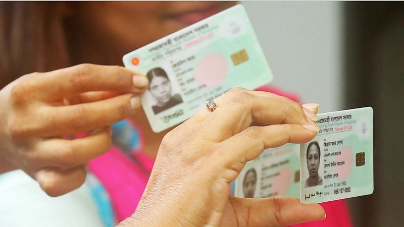 Photo shows two women holding their NID cards