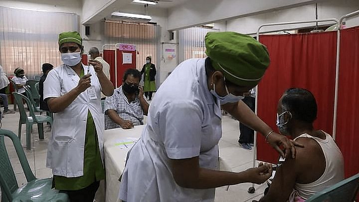 A nurse vaccinates a person at Shaheed Suhrawardy Hospital in Dhaka