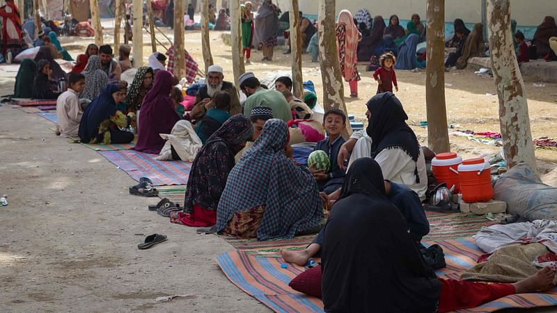 In this file photo Afghan internally displaced families are pictured upon their arrival from the outskirts Kandahar, who fled due to the ongoing battle between Taliban fighters and Afghan security forces, at a refugee camp in Kandahar on 27 July 2021.