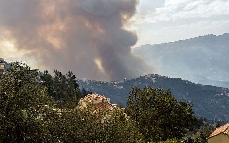 Smoke rises from a wildfire in the forested hills of the Kabylie region, east of the capital Algiers, on 10 August 2021