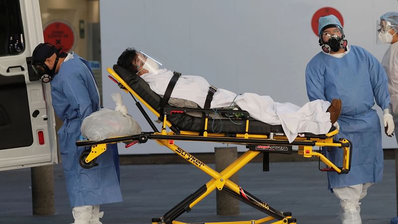 Ambulance attendants transport a patient with suspected symptoms of a coronavirus disease (COVID-19) infection to an ambulance to be transferred to another hospital, as the outbreak continues, in Mexico City, Mexico, on 13 November 2020