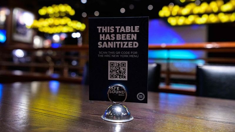 In this file photo a sign reading "This table has been sanitized" is displayed on a table at the Hard Rock Cafe on 3 May 2021 in New York City.