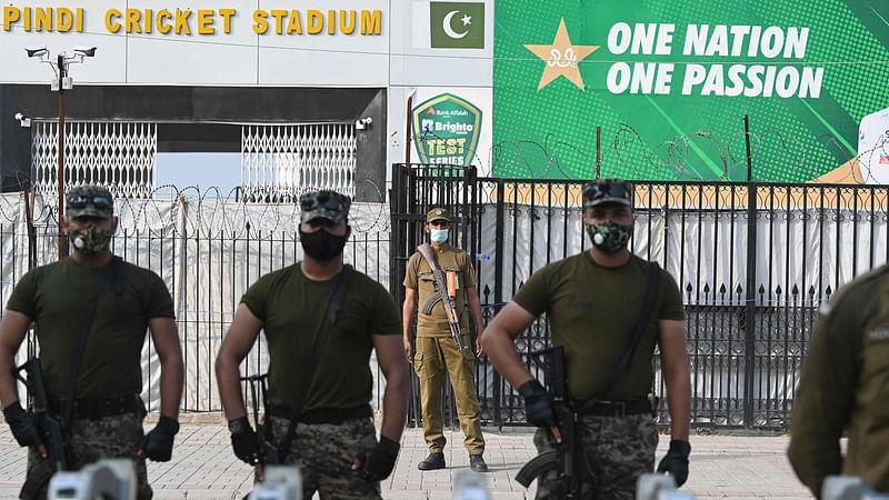 Paramilitary soldiers stand guard outside the Rawalpindi Cricket Stadium in Rawalpindi on 17 September, 2021, after New Zealand postponed a series of one-day international (ODI) cricket matches against Pakistan over security concerns