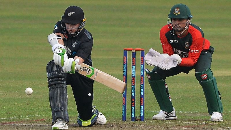 New Zealand's captain Tom Latham (L) plays a shot during the fourth Twenty20 international cricket match between Bangladesh and New Zealand at the Sher-e-Bangla National Cricket Stadium in Dhaka on 8 September 2021.