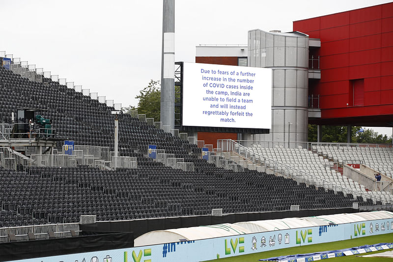 A message is seen displayed on a big screen after the match was cancelled due to members of the India staff contracting Covid-19