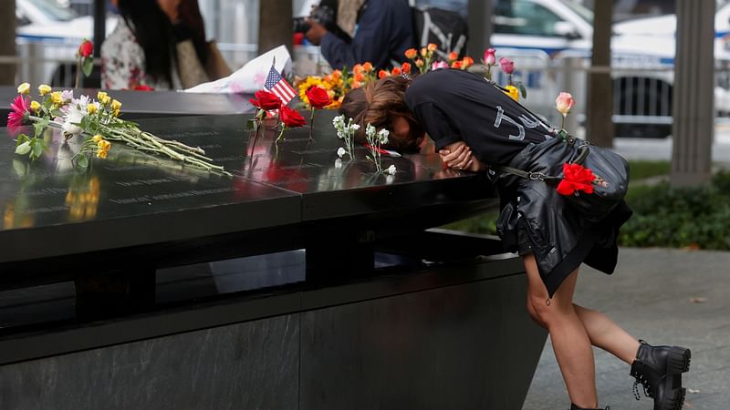 A person mourns at the 9/11 Memorial on the 20th anniversary of the 11 September 2001 attacks in New York City, New York, US, on 11 September 2021