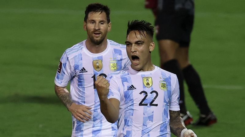 Argentina's Lautaro Martinez celebrates next to teammate Lionel Messi after scoring against Venezuela during their South American qualification football match for the FIFA World Cup Qatar 2022 at the UCV Olympic Stadium in Caracas on 2 September 2021