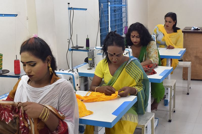 In this picture taken on 25 June 2021, transgender people work at Uttoron Fashion And Shopno Tailors garment factory owned by Apon Akhter, a transgender in Dhaka